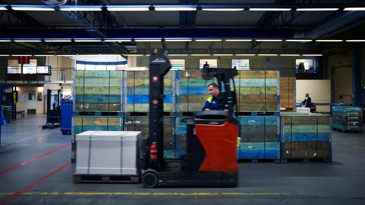 Man drives forklift with pallets on