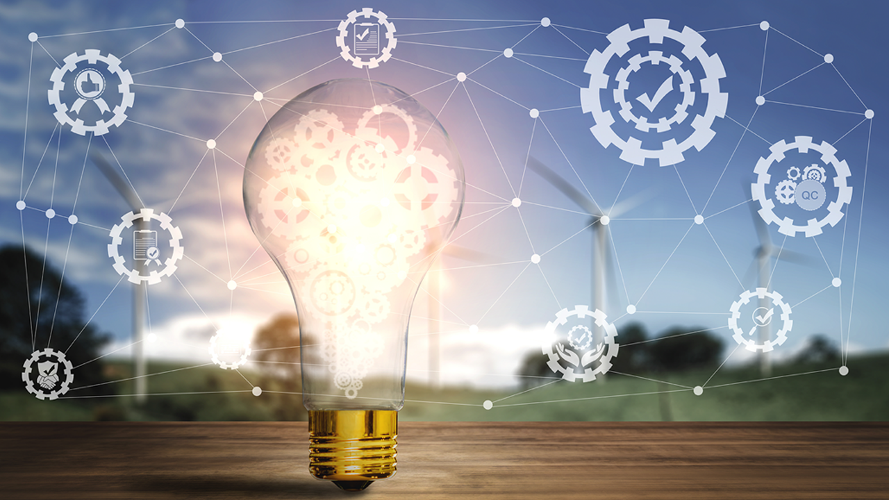 A glowing lightbulb filled with gear icons