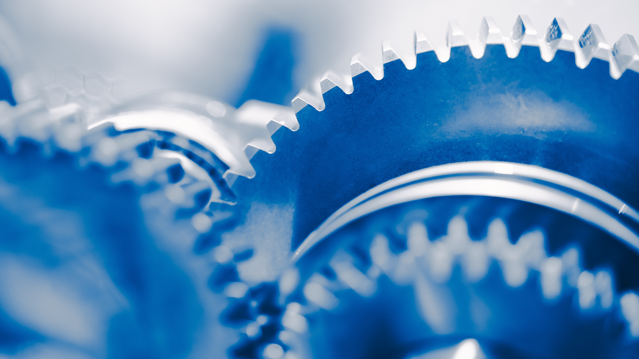 Close-up of interlocking metallic gears in motion